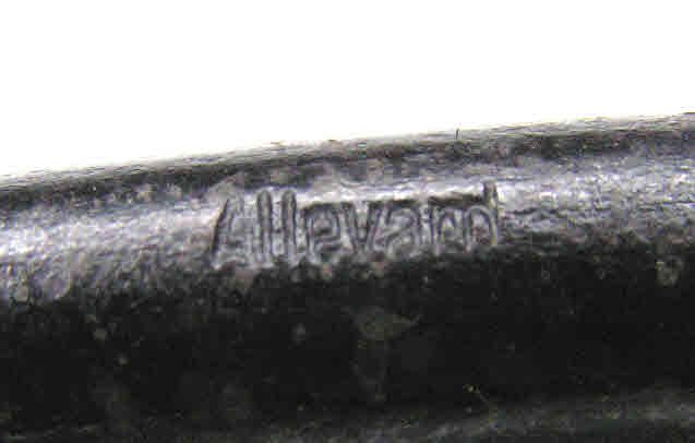 Close-up of a blackened Bulle bar magnet with the word Allevard stamped into it