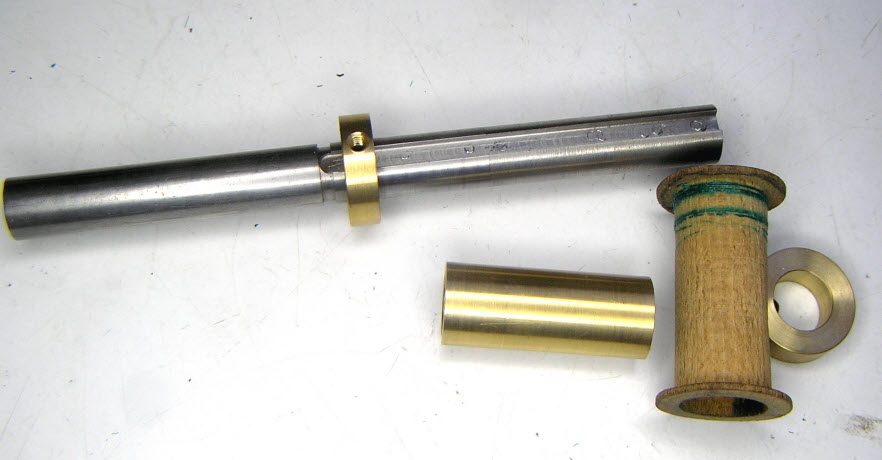 Lathe arbour with a collet and a wooden coil bobbin used for rewinding a Bulle coil